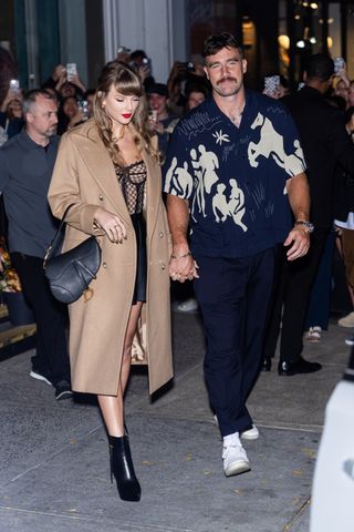 Taylor Swift and Travis Kelce on a date in new york city where taylor swift wears a camel coat with a dior bag and ankle boots