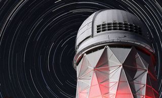 A photo of a tower with a long-exposure image of stars behind it