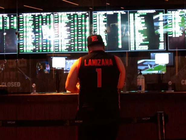 A man makes a sports bet at the Borgata casino in Atlantic City NJ, ahead of the NCAA March Madness tournament