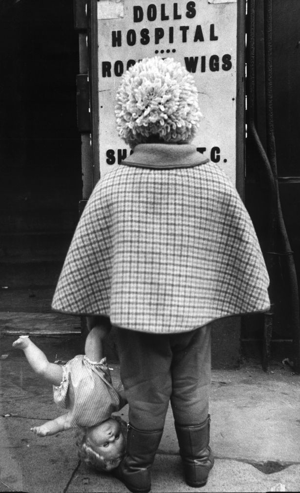 A young girl outside the Original Dolls Hospital, Piccadilly, Manchester. 17th January 1969