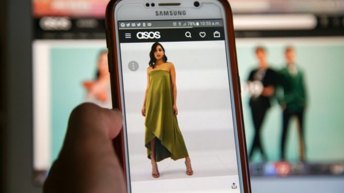 Asos Shares Plunge Following Public Data Breach Threat Model in green dress on a moblile phone with Asos.