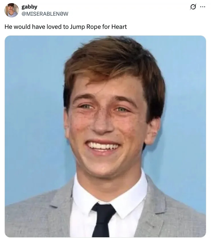 Skyler Gisondo smiling in a suit and tie with caption about him loving "Jump Rope for Heart."