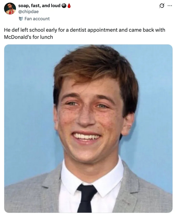 Skyler Gisondo in a light suit and tie smiling for a photo. Tweet text humorously suggests he left school for a dentist and returned with McDonald's