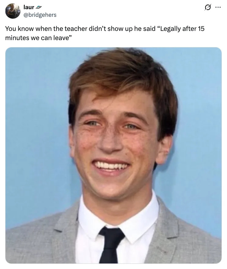 Skyler Gisondo smiling, wearing a suit with a tie. The tweet above says, "You know when the teacher didn't show up he said 'Legally after 15 minutes we can leave'."