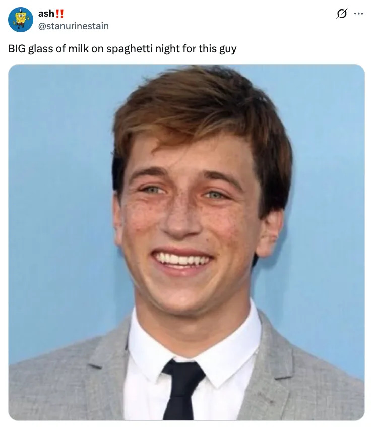 Skyler Gisondo in a suit smiling, with a caption about drinking a big glass of milk on spaghetti night