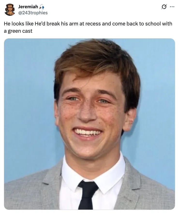 Skyler Gisondo in a suit and tie with a humorous tweet above about breaking his arm at recess and returning with a green cast