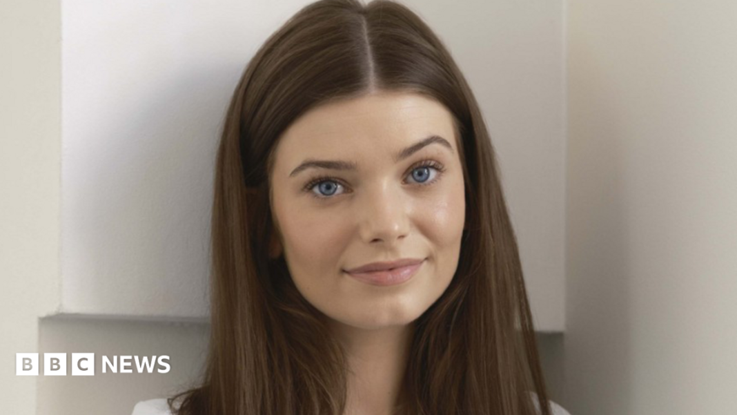Leisa Gwenllian follows in footsteps of Hollywood stars in line-up A close-up portrait of Leisa looking directly at the camera. She has straight brown hair reaching past her shoulders, which is parted in the middle. She stands indoors with a plain, light-coloured background.