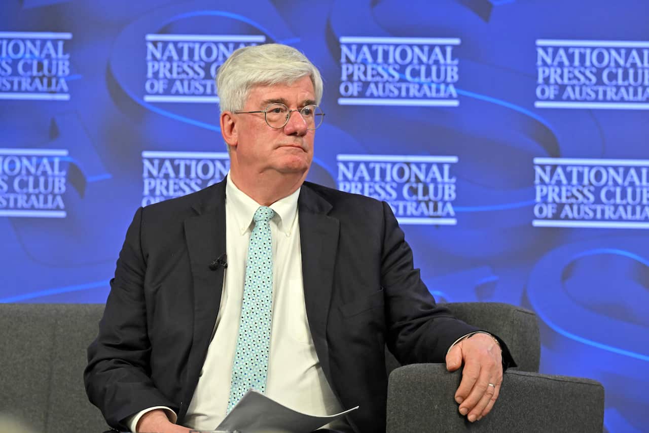 An older white man in a suit at the National Press Club.