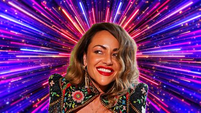 Headshot of Jamie Winstone in front of branding for Strictly Come Dancing 2026 - a background of glittering pink, purple and gold beams of light.