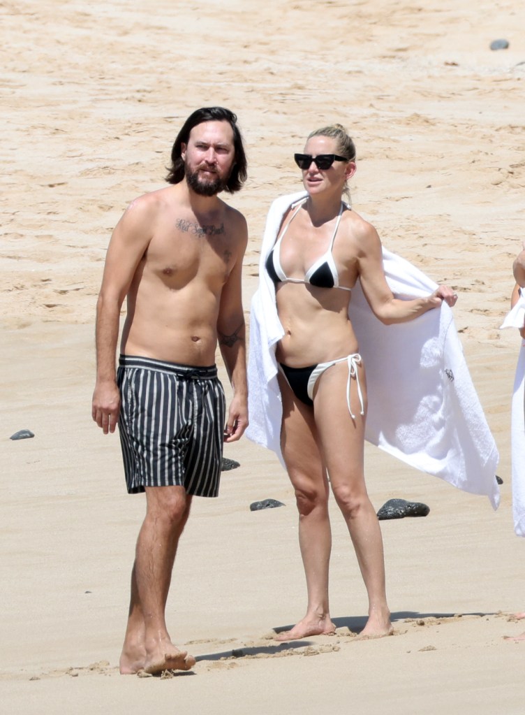 Kate Hudson and Danny Fujikawa on a beach in Hawaii.
