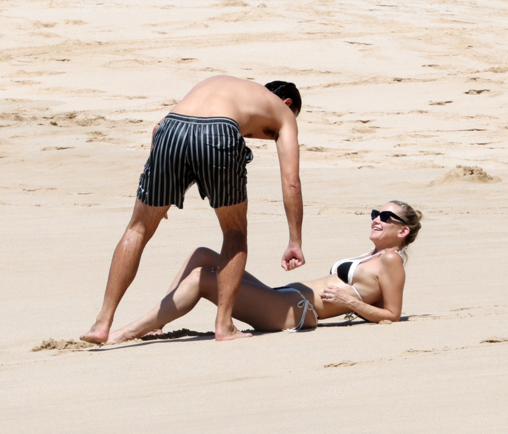 Kate Hudson and Danny Fujikawa on a beach in Hawaii.
