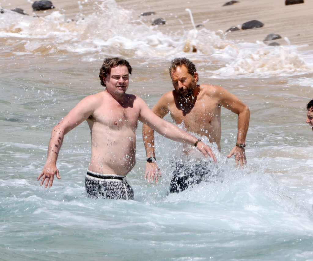 Leonardo DiCaprio swimming in the ocean with a friend in Hawaii.