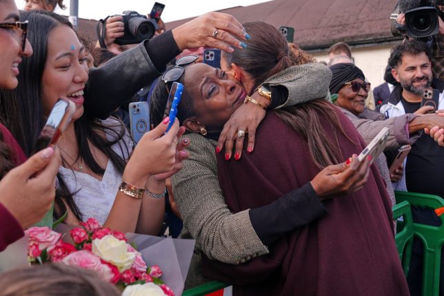 Britain's Meghan, Duchess of Sussex is hugged by a member of the public as she departs after a visit to The Community Recording Studio in Nottingham, England, Thursday, Oct. 15, 2026. (AP Photo/Maja Smiejkowska)