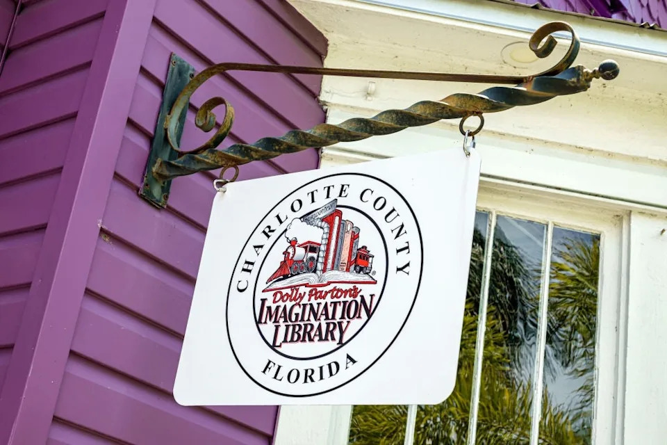 Sign for Charlotte County, Florida, displaying "Dolly Parton's Imagination Library" with an illustration of books and a train