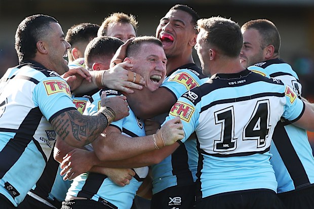 Paul Gallen of the Sharks celebrates kicking a field goal with team mates during the round 25 NRL match between the Wests Tigers and the Cronulla Sharks