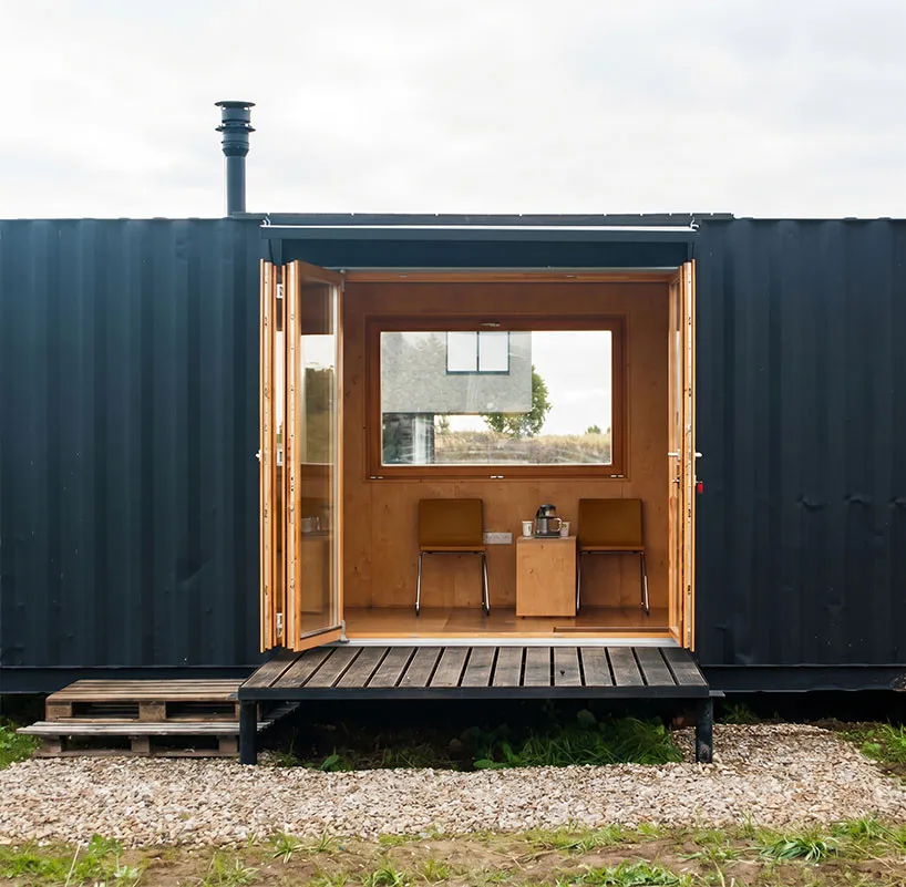 Innovative Birch Plywood Interior Transforms Shipping Container into Modern Micro-Cabin Self-contained transportable unit offering flexible relocation options.