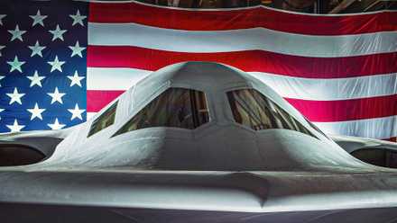 Close up of the B-21 cockpit area with the American flag as a backdrop.