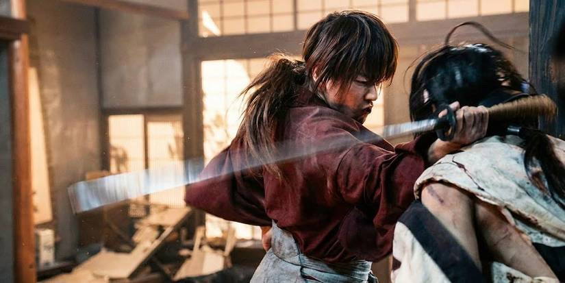 An intense indoor sword battle scene featuring Kenshin Himura in Rurouni Kenshin: The Final