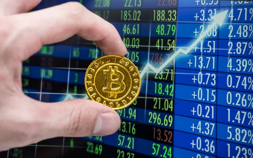 The Bitcoin Bull Market Is Finally Here, According to Strategy’s Michael Saylor. Could Bitcoin Hit a Price of $100,000 in 2027? Hand holding a golden Bitcoin with upward arrow.
