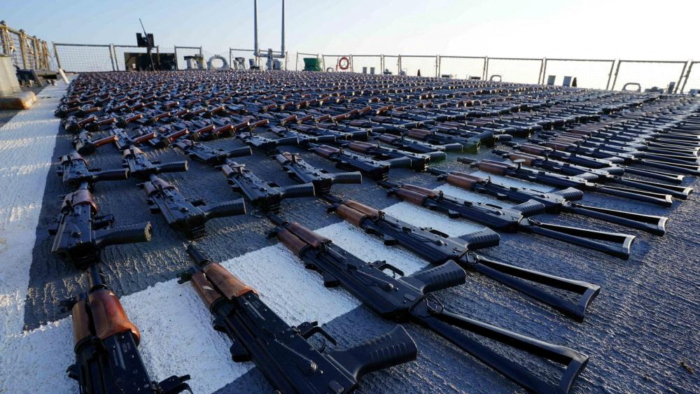 Thousands of AK-47 assault rifles, seized from a fishing vessel transiting from Iran to Yemen, sit on the flight deck of a US destroyer in the Gulf of Oman, Jan. 7, 2023. (Reuters file)