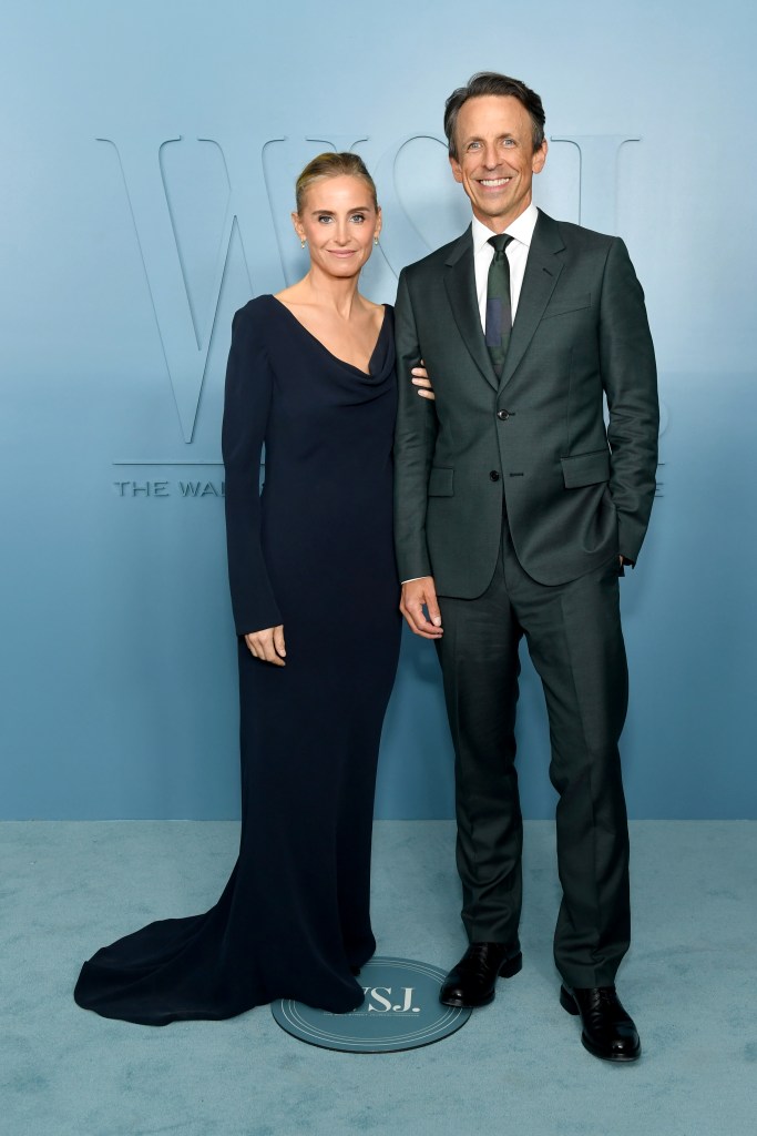 Alexi Ashe and Seth Meyers pose on the red carpet at an event.
