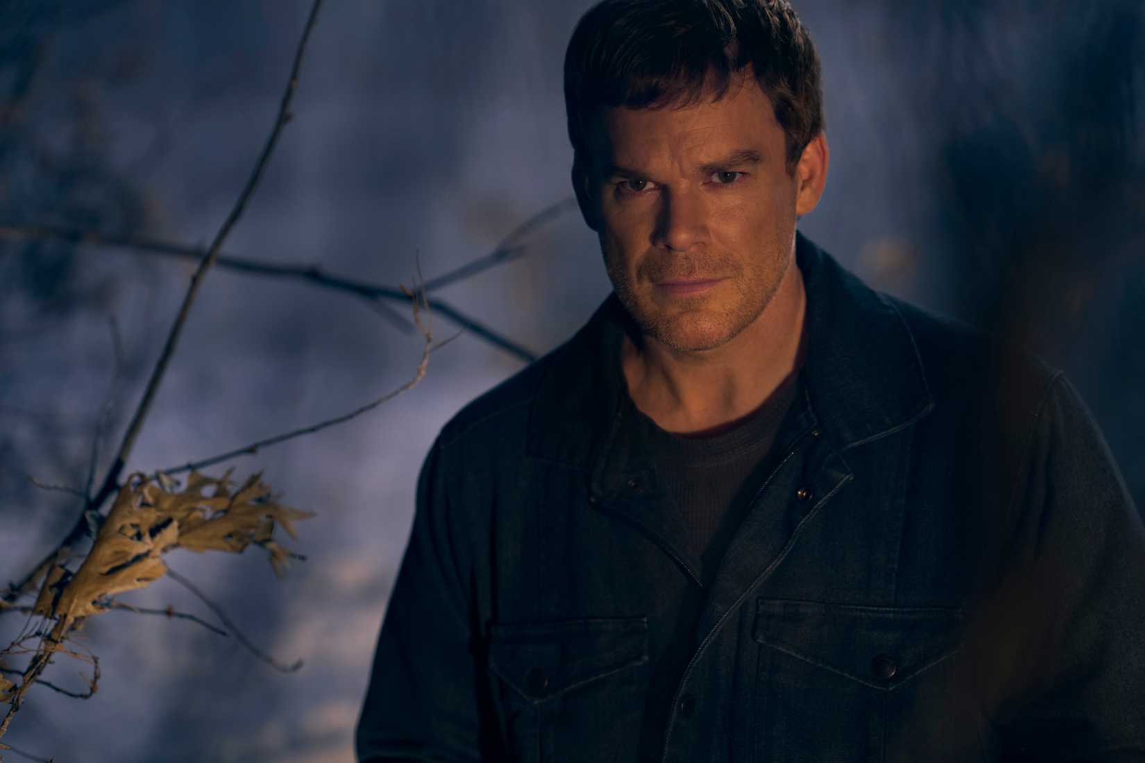 Dexter Morgan stands in a dark cloak in the snowy woods in Showtime’s Dexter: New Blood