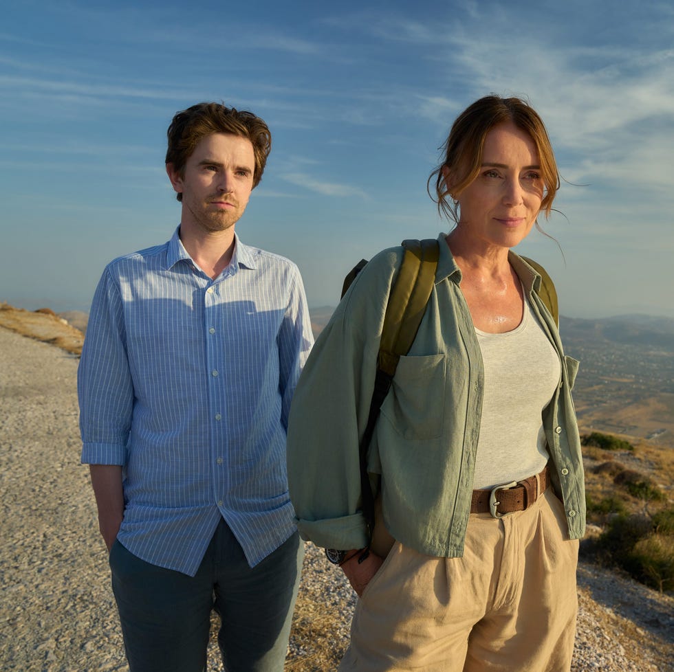 two people standing on a scenic mountain path at sunset. two people standing on a scenic mountain path at sunset.